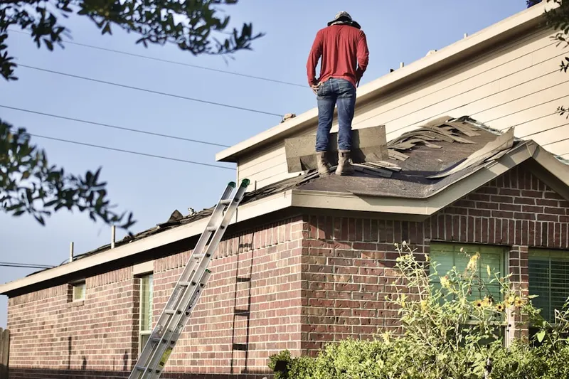 Professional roofer working on a residential roof in Fort George Island